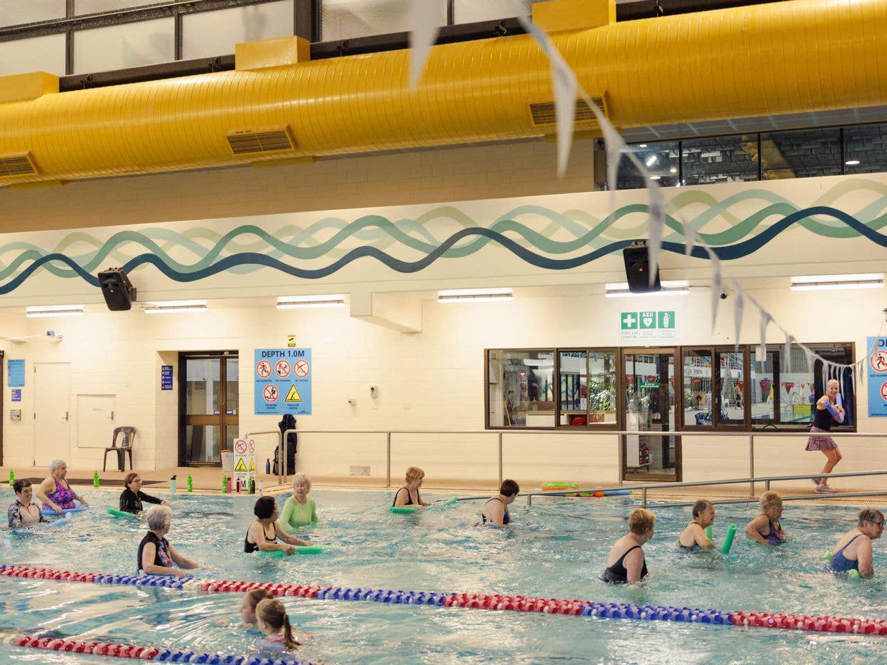 Multiple people in a pool taking an aquatic class