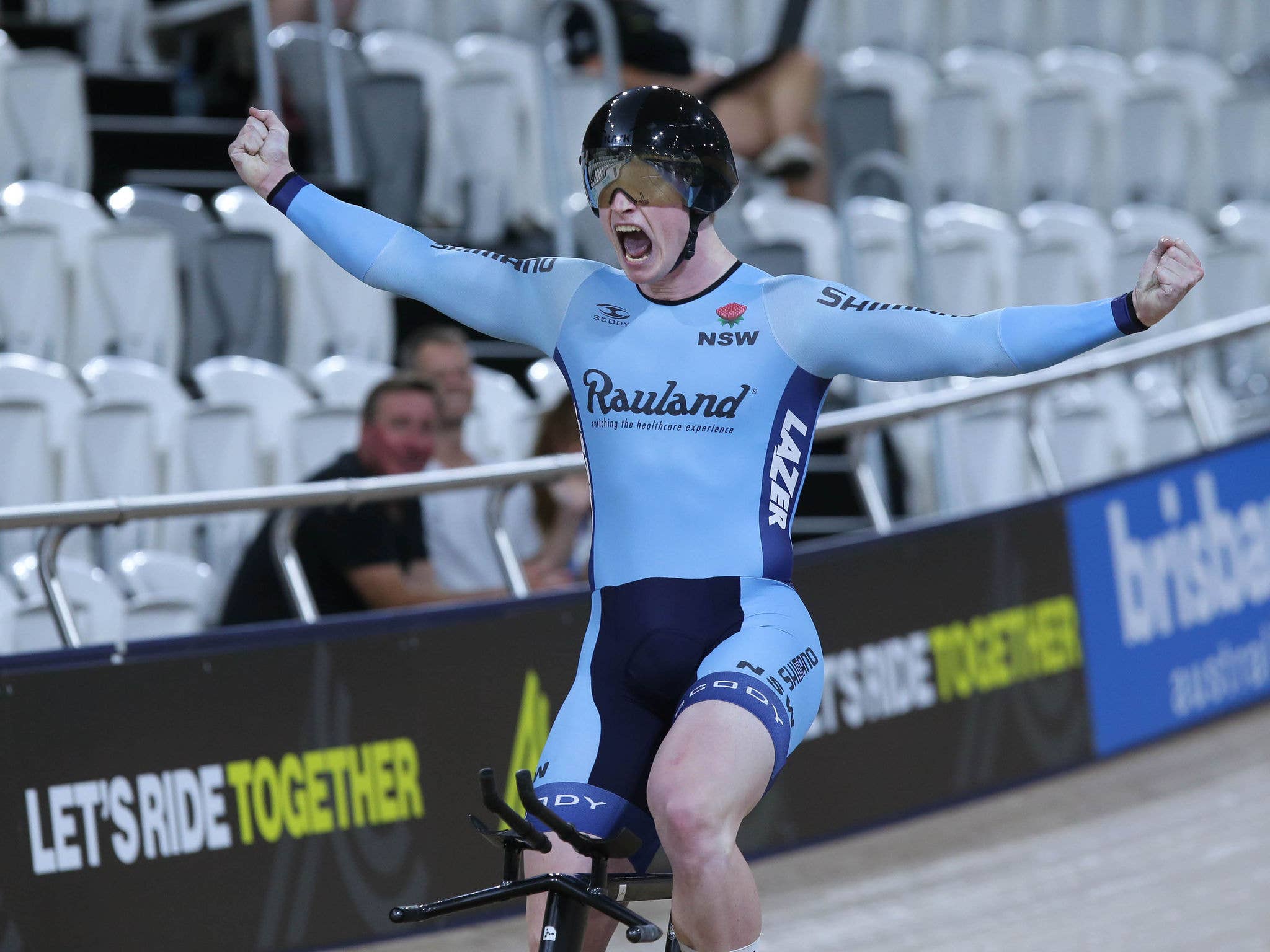 A cyclist is cheering on the track