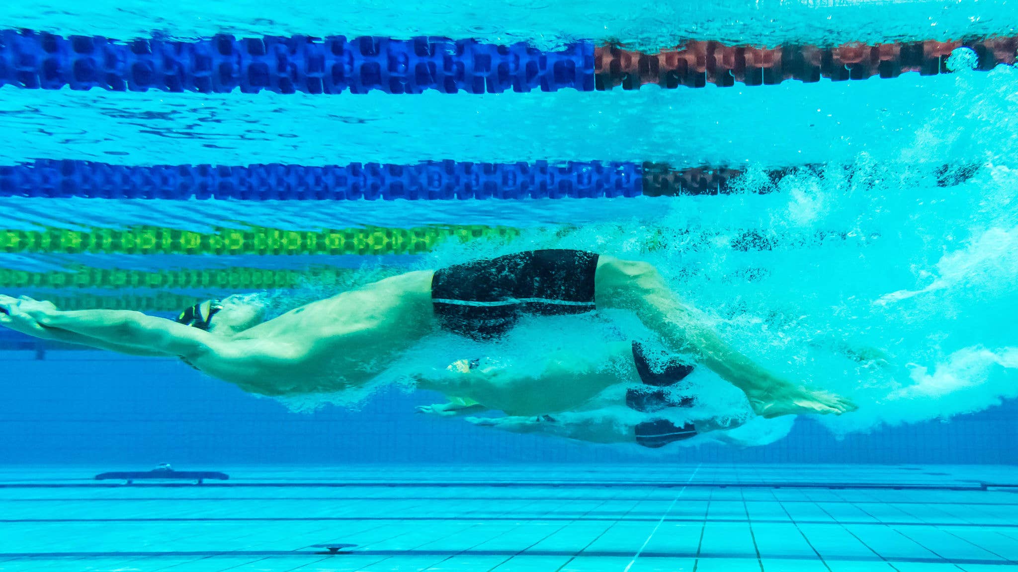 A backstroke swimmer underwater having just pushed off the wall