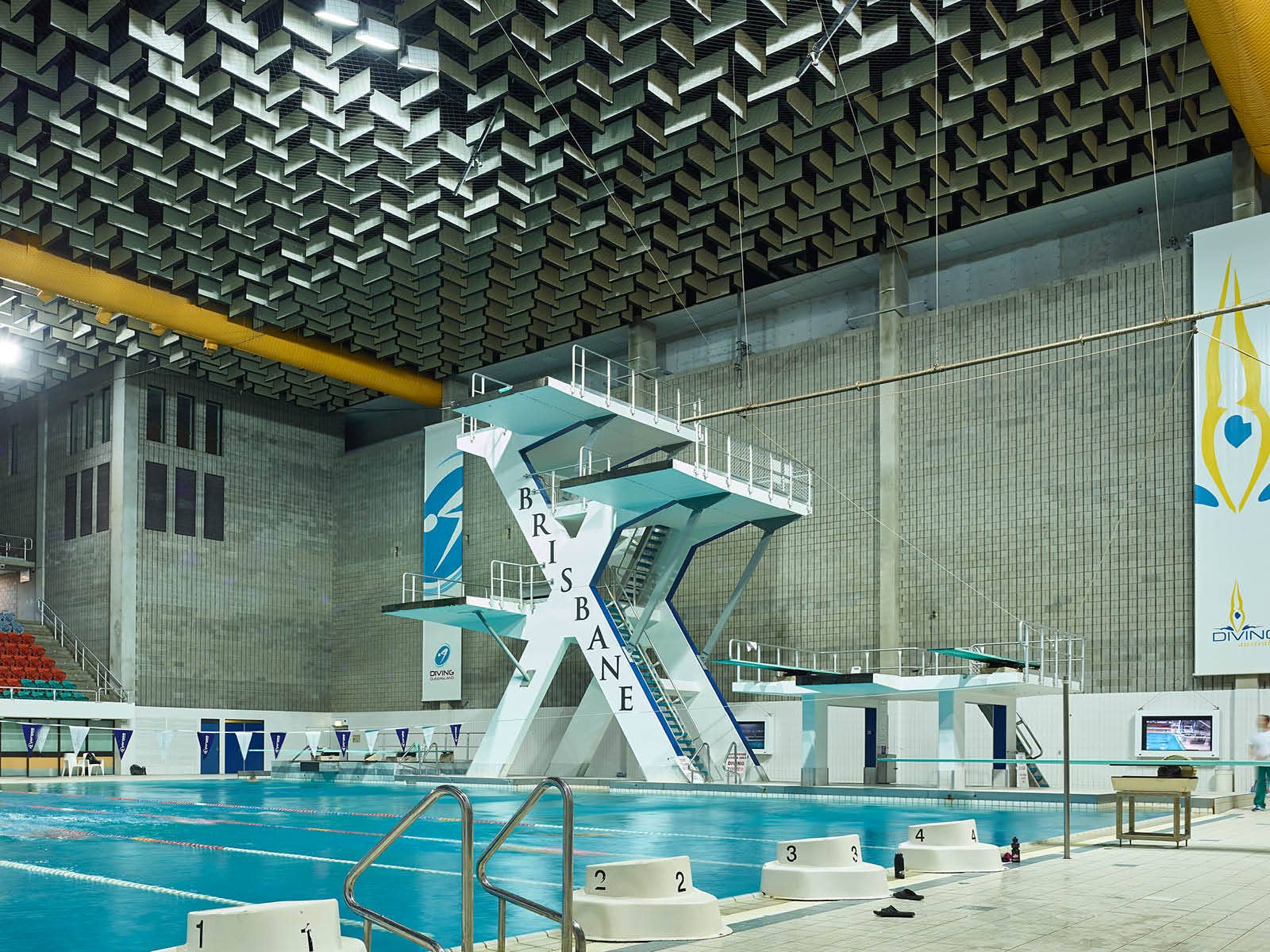 Pool with starting blocks and dive tower in the background