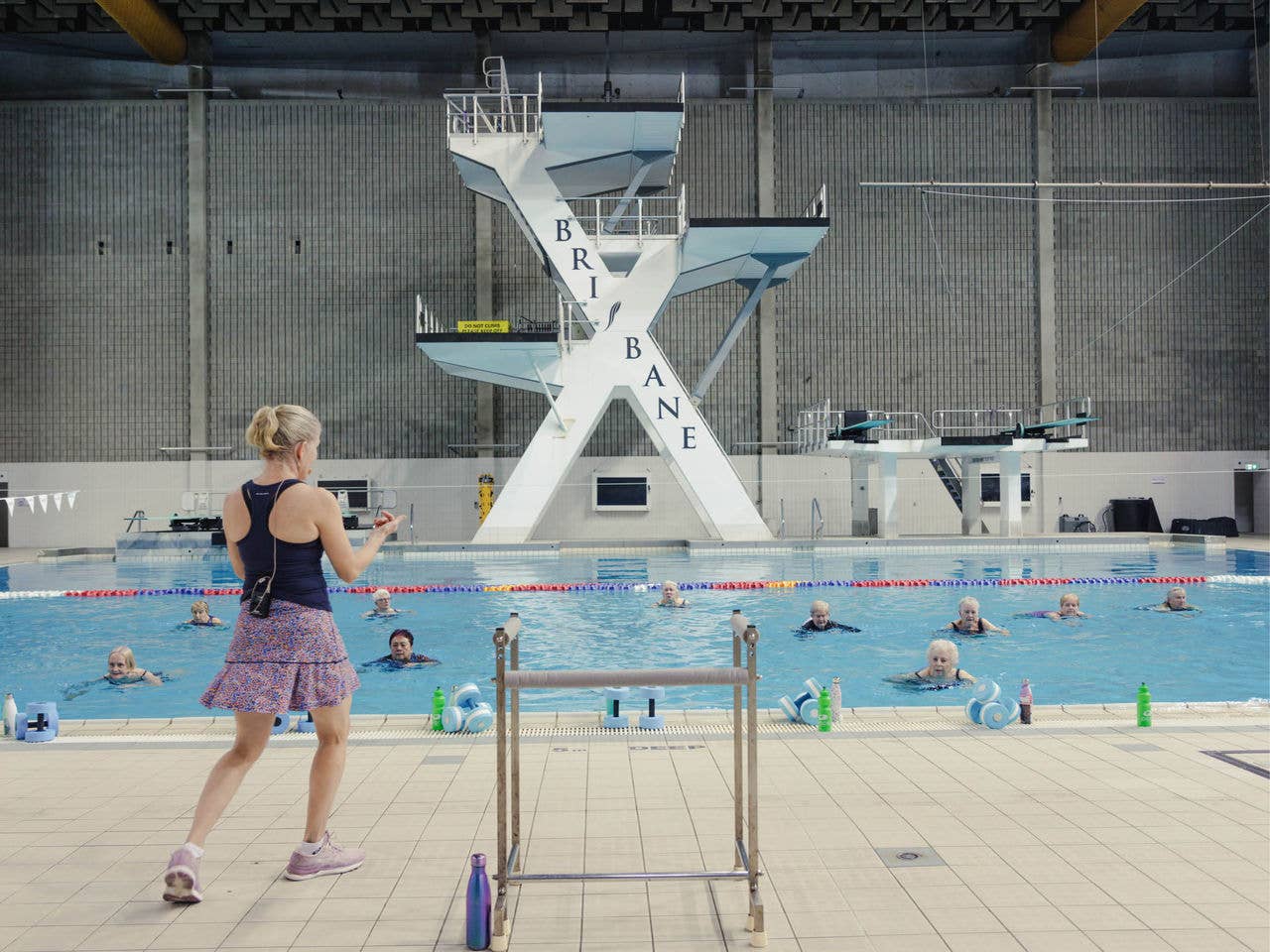 An instructor teaches a deep aqua class in the dive pool