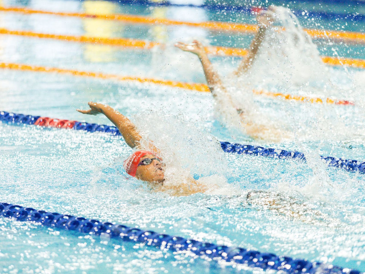 Kid swimming backstroke 