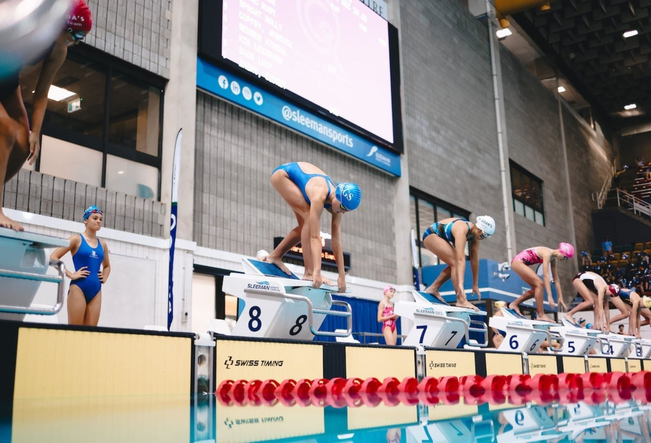 Swimmers diving off the blocks